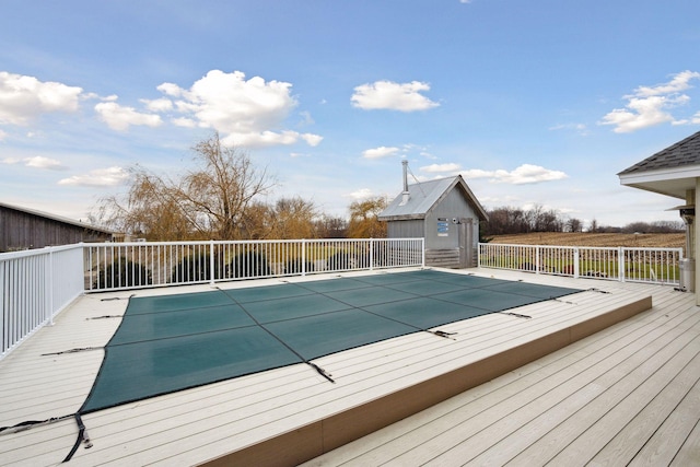 view of pool with a fenced in pool and a wooden deck