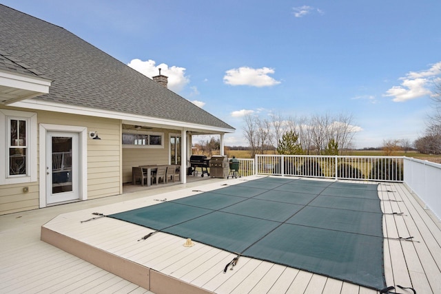 view of pool featuring a fenced in pool, a wooden deck, and outdoor dining space