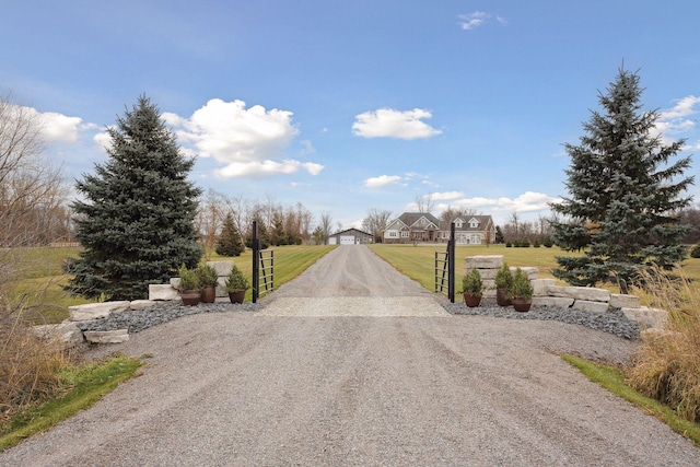 view of street with driveway and a gated entry