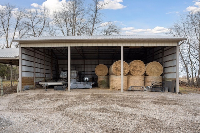 view of car parking with a detached carport and an outbuilding