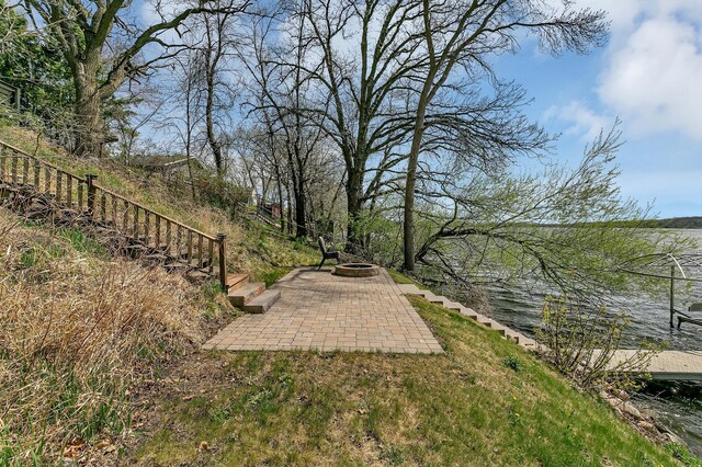 view of yard with a patio, stairs, and an outdoor fire pit
