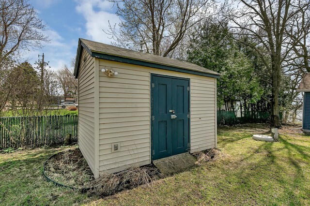 view of shed with fence