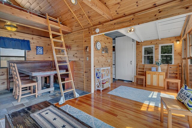 interior space with wood walls, wood ceiling, and wood finished floors