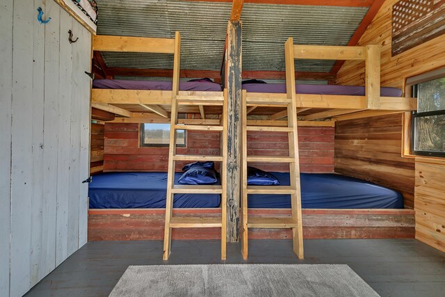 bedroom featuring wooden walls