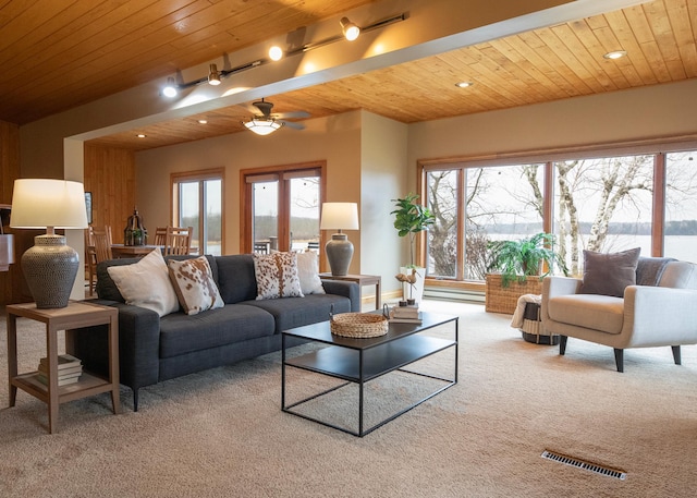 living room with carpet, visible vents, and wooden ceiling