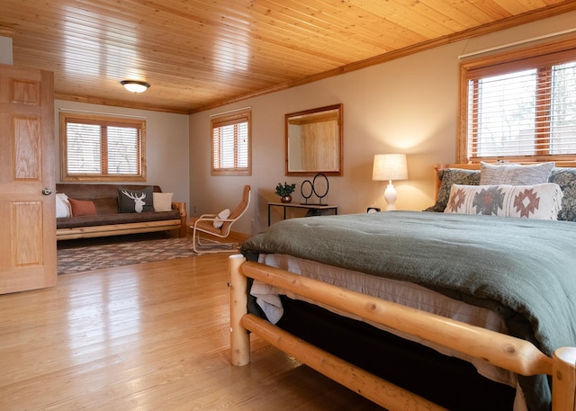 bedroom featuring wood ceiling, wood finished floors, and crown molding
