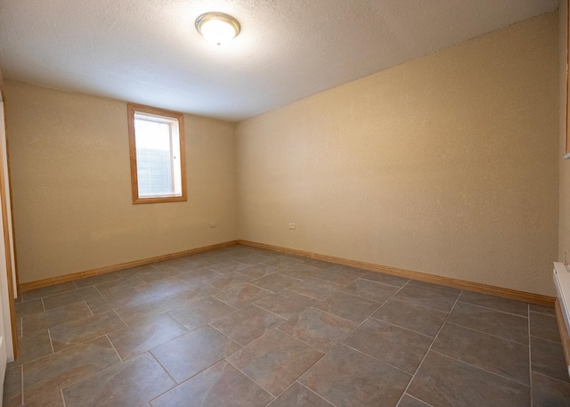 spare room featuring baseboards