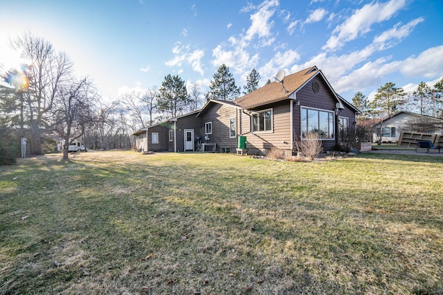 rear view of house featuring a lawn