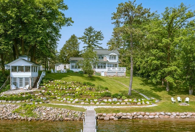 9472 Rocky Point Trl, Lake Shore, MN 56468 - rear view of property with a sunroom, stairway, a water view, and a lawn