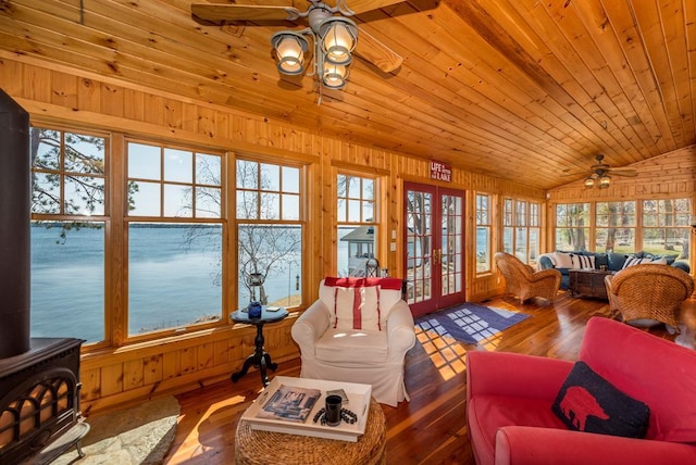 9472 Rocky Point Trl, Lake Shore, MN 56468 - sunroom with french doors, vaulted ceiling, wooden walls, a wood stove, and wood-type flooring
