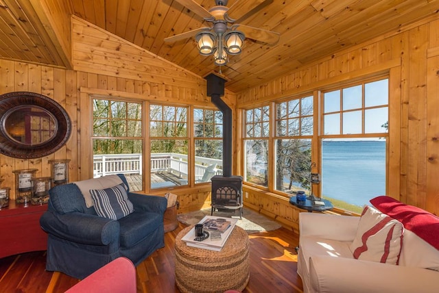 9472 Rocky Point Trl, Lake Shore, MN 56468 - living area with a wood stove, wood ceiling, wood-type flooring, ceiling fan, and wooden walls