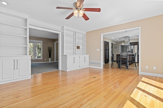 1337 Kenilworth Dr, Woodbury, MN 55125 - living area with ceiling fan, visible vents, built in features, baseboards, and light wood-style flooring