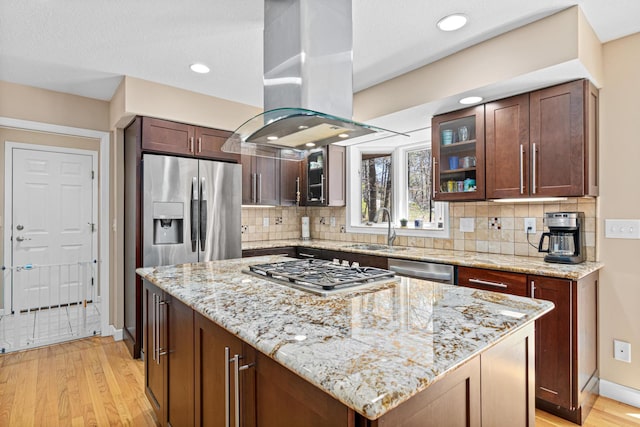 1337 Kenilworth Dr, Woodbury, MN 55125 - kitchen with a sink, light wood-style floors, stainless steel appliances, island range hood, and glass insert cabinets
