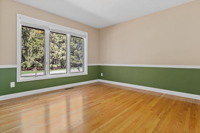 1337 Kenilworth Dr, Woodbury, MN 55125 - empty room with baseboards, wood finished floors, and visible vents