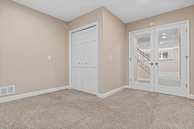 1337 Kenilworth Dr, Woodbury, MN 55125 - unfurnished bedroom featuring carpet floors, baseboards, visible vents, and french doors