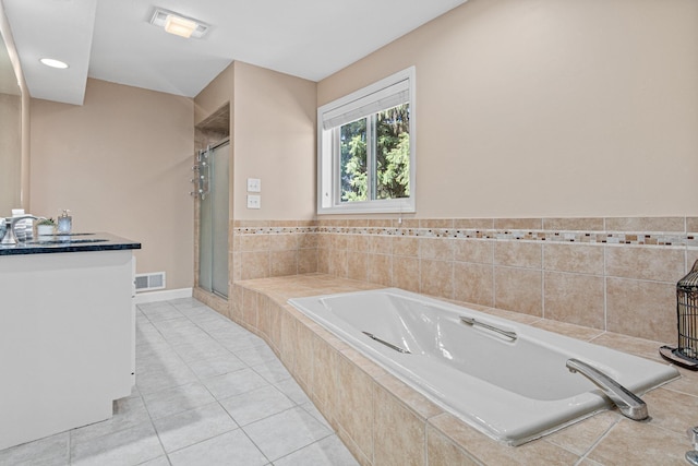 1337 Kenilworth Dr, Woodbury, MN 55125 - bathroom with vanity, tile patterned floors, visible vents, a garden tub, and a stall shower