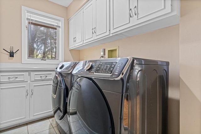 1337 Kenilworth Dr, Woodbury, MN 55125 - laundry area featuring light tile patterned floors, cabinet space, and washer and clothes dryer