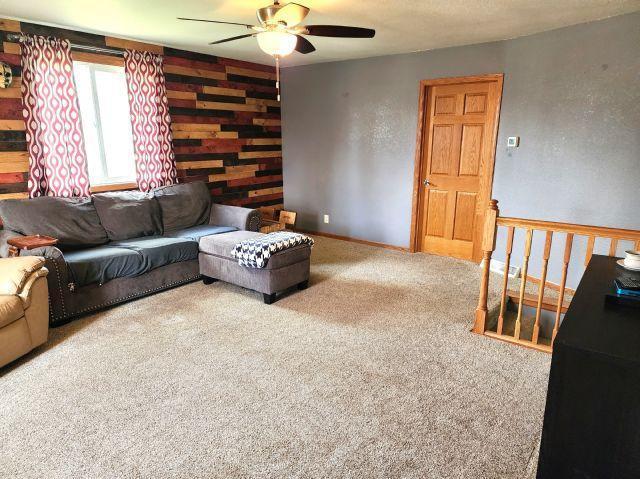 21 Main St, Luck, WI 54853 - living area with a ceiling fan and carpet floors