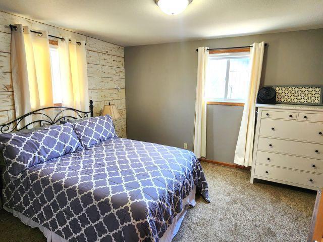 21 Main St, Luck, WI 54853 - bedroom with carpet floors and wooden walls