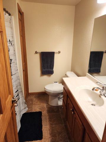 21 Main St, Luck, WI 54853 - full bathroom with vanity and tile patterned flooring
