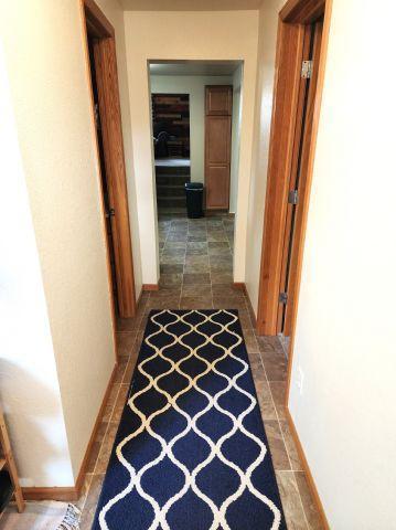 21 Main St, Luck, WI 54853 - hallway featuring baseboards and stone finish floors