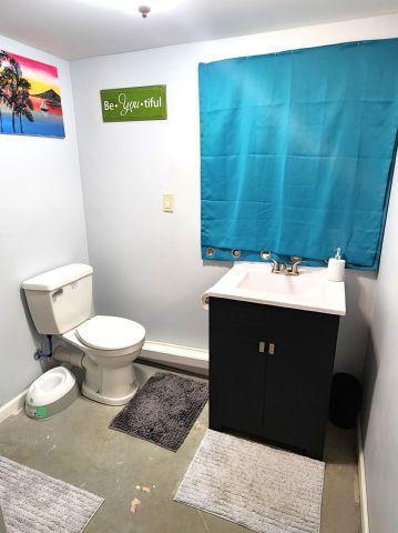21 Main St, Luck, WI 54853 - half bathroom featuring vanity and concrete floors