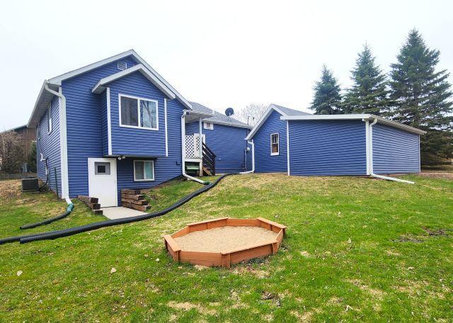 21 Main St, Luck, WI 54853 - back of house featuring a lawn