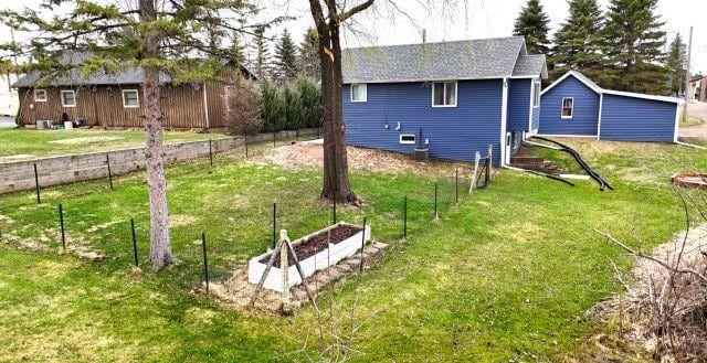 21 Main St, Luck, WI 54853 - view of home's exterior featuring a garden