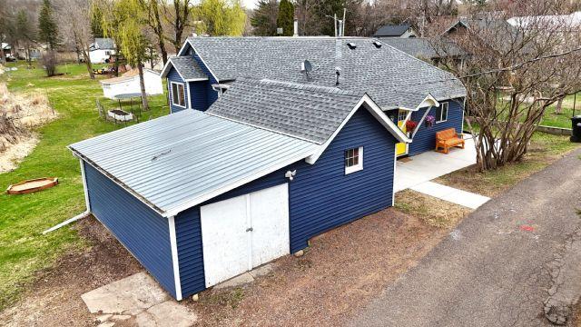 21 Main St, Luck, WI 54853 - back of house with a yard and a metal roof