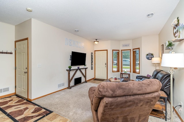 living room with light carpet, baseboards, and visible vents