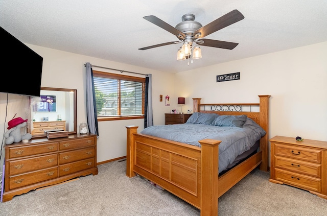 bedroom featuring light carpet and ceiling fan