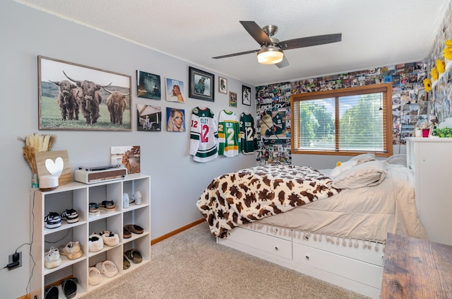 bedroom with a ceiling fan, baseboards, carpet floors, and a textured ceiling
