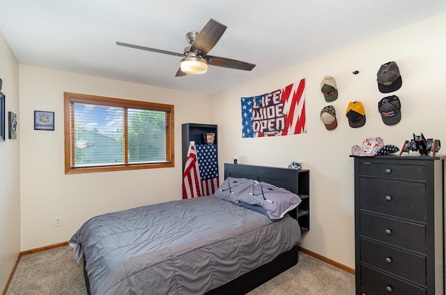 carpeted bedroom featuring baseboards and ceiling fan