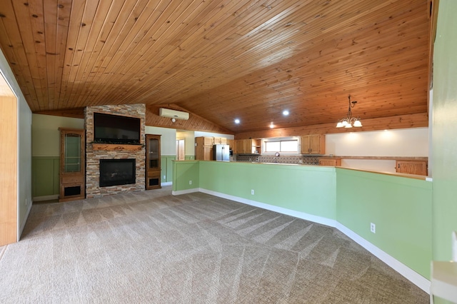 unfurnished living room featuring lofted ceiling, carpet, a stone fireplace, and wooden ceiling