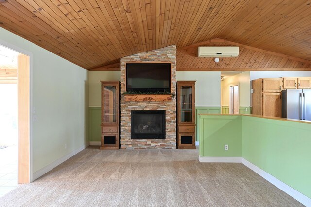 unfurnished living room with wooden ceiling, light colored carpet, vaulted ceiling, a fireplace, and a wall mounted AC