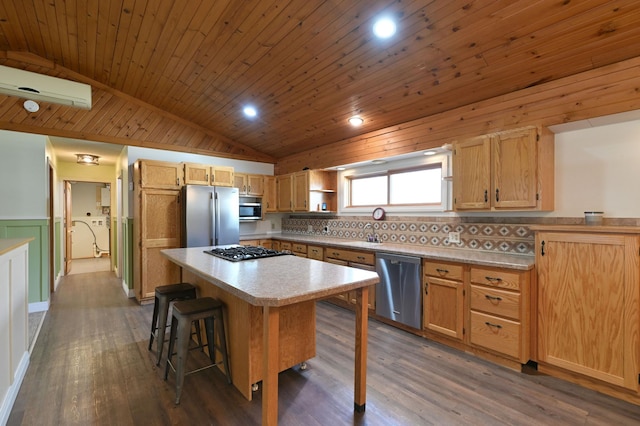 kitchen featuring a breakfast bar area, stainless steel appliances, a center island, wooden ceiling, and vaulted ceiling