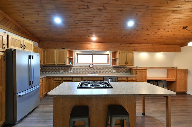 kitchen featuring a breakfast bar area, tasteful backsplash, stainless steel appliances, and open shelves