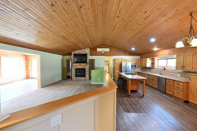 kitchen featuring wood ceiling, stainless steel appliances, vaulted ceiling, a stone fireplace, and open floor plan