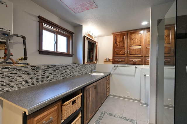 interior space featuring a textured ceiling, recessed lighting, tile patterned floors, vanity, and backsplash