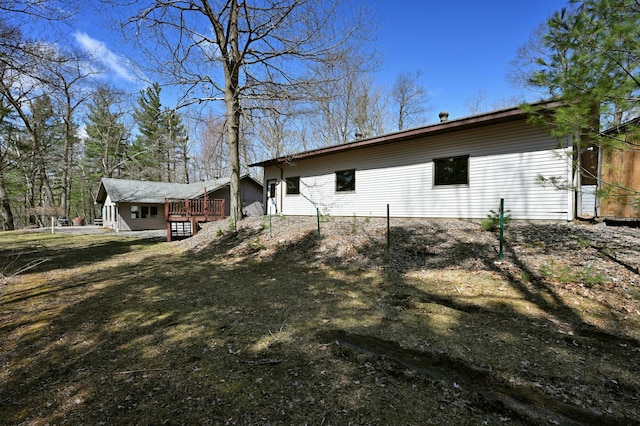 view of side of home with a wooden deck