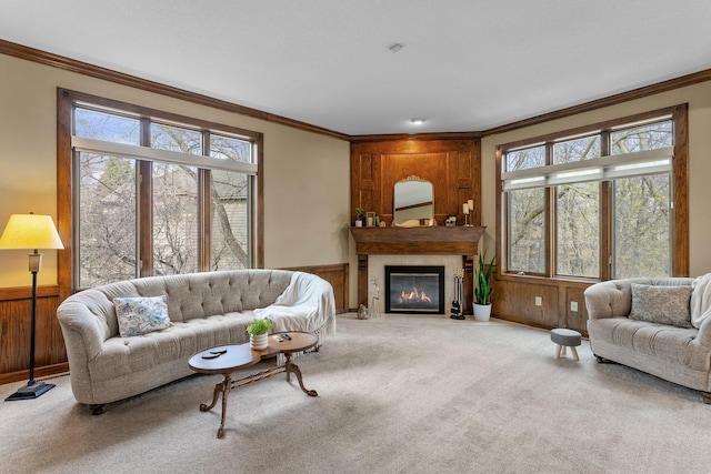 living area with crown molding, carpet flooring, and plenty of natural light