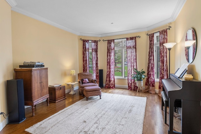 sitting room featuring crown molding and wood finished floors