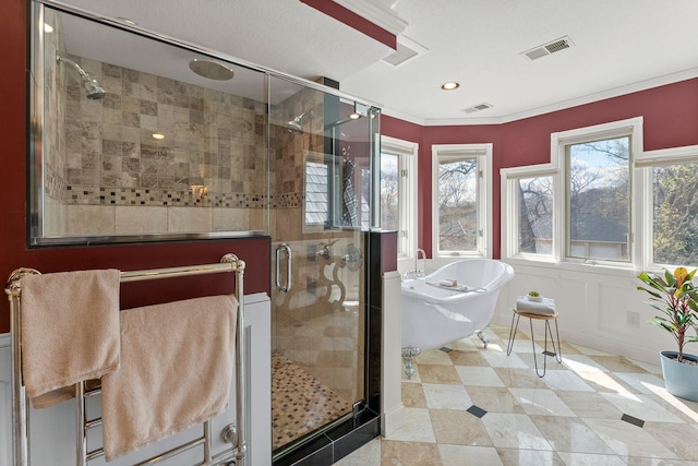 full bathroom with crown molding, visible vents, a shower stall, and a freestanding bath