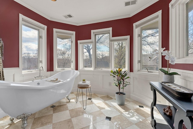 bathroom with visible vents, a healthy amount of sunlight, and a decorative wall