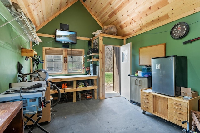 interior space with concrete floors, a workshop area, wooden ceiling, and lofted ceiling