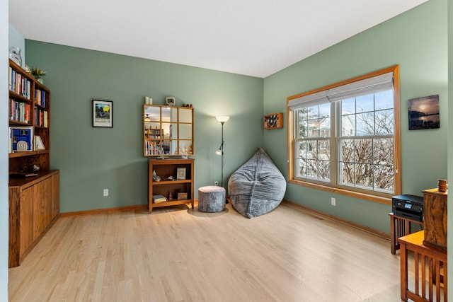 misc room featuring baseboards and wood finished floors