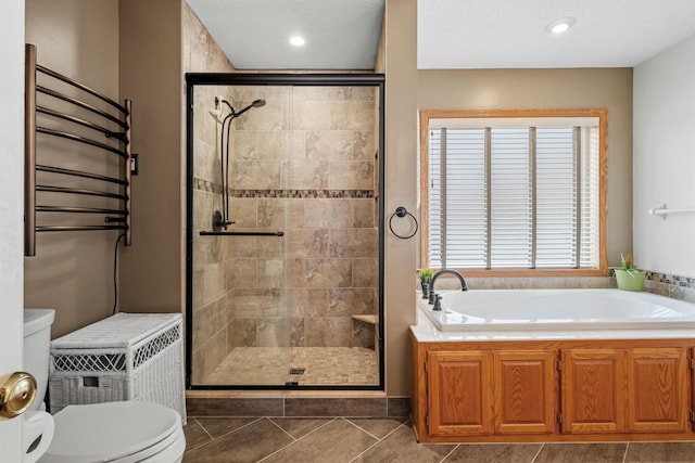 bathroom featuring a stall shower, a bath, radiator, and toilet