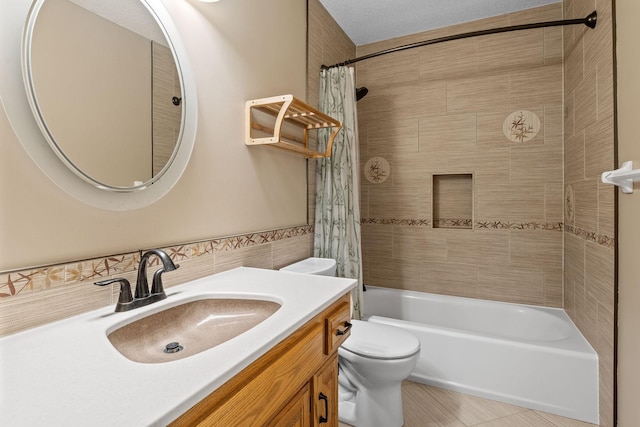 bathroom featuring vanity, toilet, tile walls, tile patterned flooring, and shower / bath combination with curtain