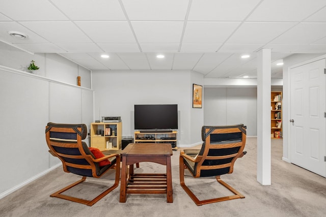 sitting room featuring a paneled ceiling and carpet flooring