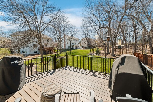 deck featuring a lawn and a residential view